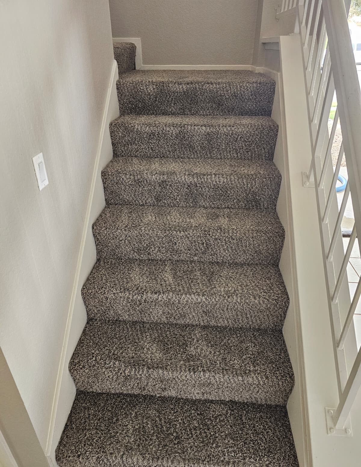 Clean carpeted staircase with fresh vacuum lines