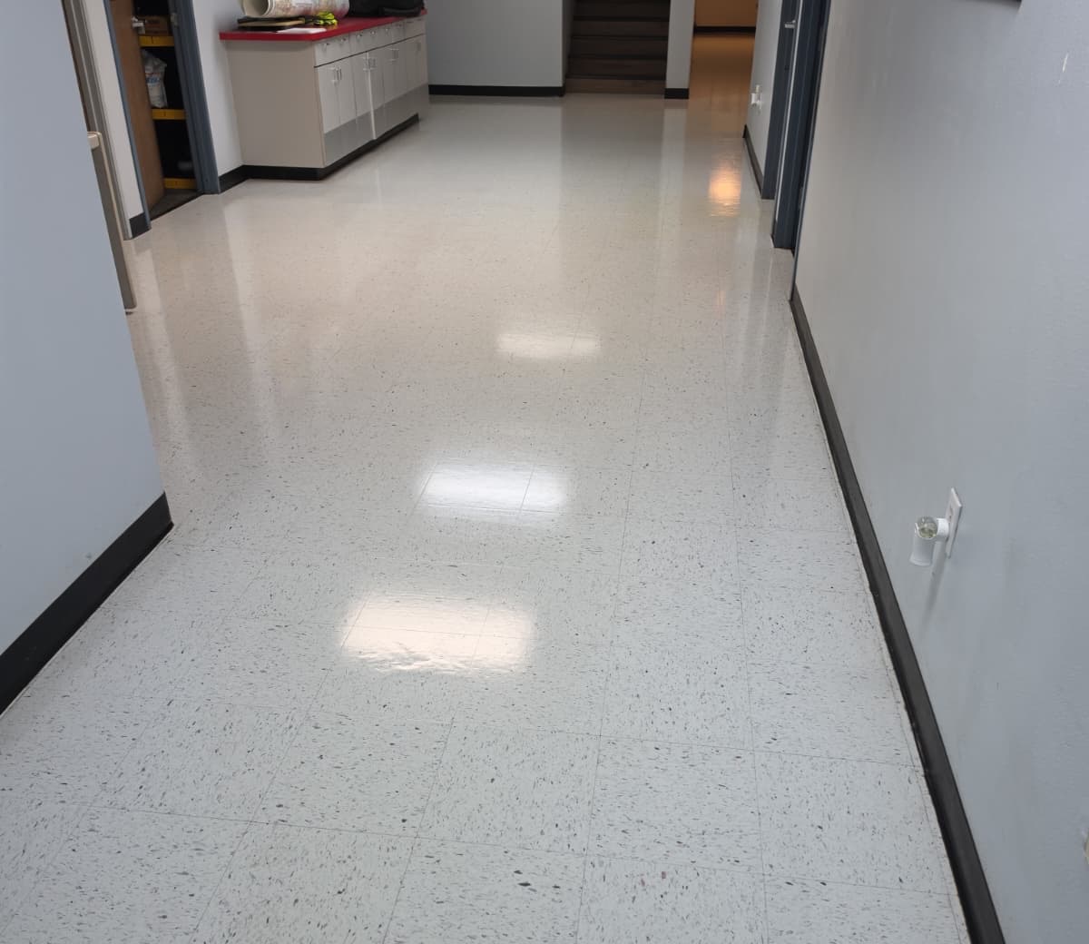 Glossy commercial hallway floor after stripping and waxing