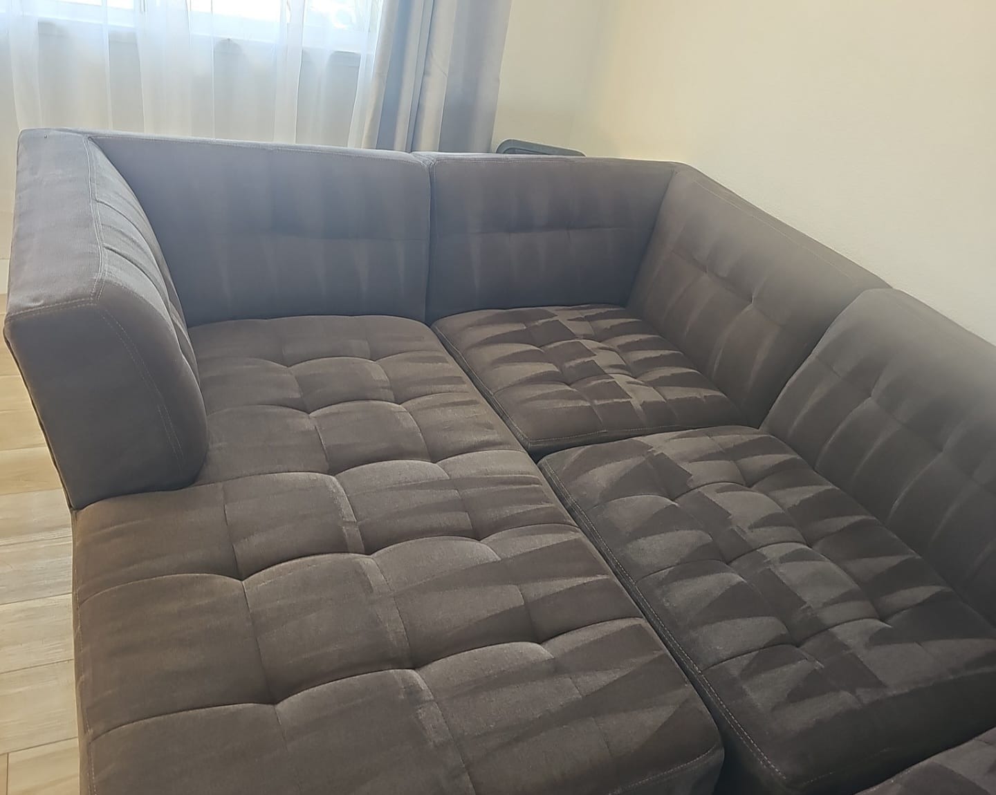 Close-up of freshly steam-cleaned sectional sofa upholstery